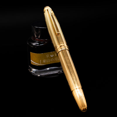 Uncapped Montblanc Meisterstück 146V Vermeil Pinstripe LeGrand Fountain Pen with nib facing ink bottle