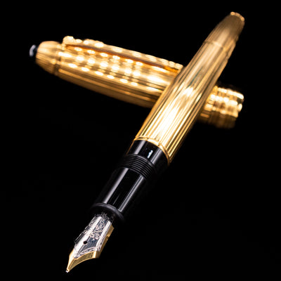 Open Montblanc Meisterstück 146V Vermeil Pinstripe LeGrand Fountain Pen with cap placed at an angle