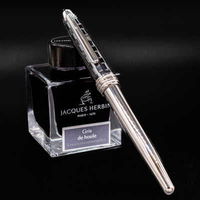 Montblanc Meisterstuck 163 Ceramics Prisma Rollerball Pen capped and resting on Jacques Herbin ink bottle