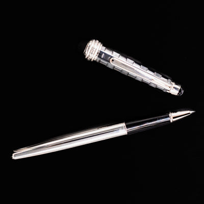 Flatlay image of the Montblanc Meisterstück 163 Solitaire Ceramics Prisma Rollerball Pen with cap and barrel shown separately