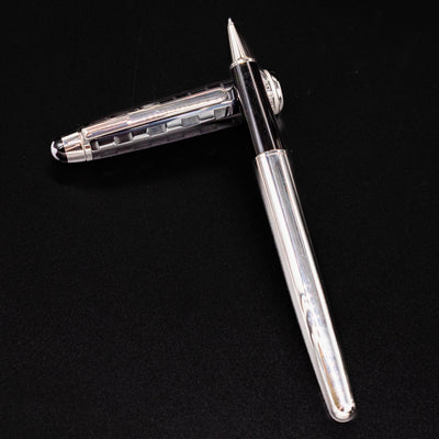 Uncapped Montblanc Meisterstuck 163 Solitaire Ceramics Prisma Rollerball Pen with cap beside it on black background