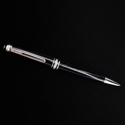 Full view of the Montblanc Meisterstück 164 UNICEF Black & Platinum Ballpoint Pen on black background – preowned