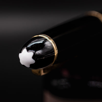 Close-up of the Montblanc LeGrand Mechanical Pencil finial showcasing the white snowcap emblem on the black resin cap.