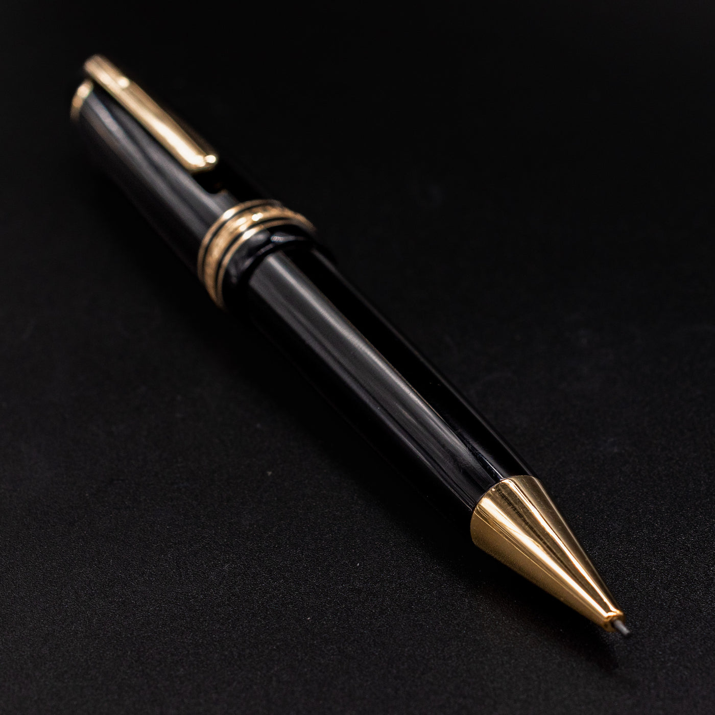 Angled view of the Montblanc Meisterstück 167 LeGrand Mechanical Pencil showing its glossy black resin body and gold trim.