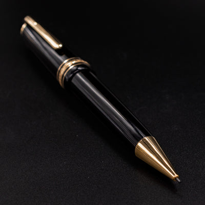 Angled view of the Montblanc Meisterstück 167 LeGrand Mechanical Pencil showing its glossy black resin body and gold trim.