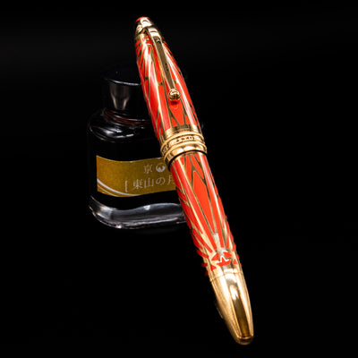 Montblanc Meisterstuck The Origin Collection Solitaire Doue LeGrand Fountain Pen capped and placed on Jacques Herbin Gris de Houle ink bottle.