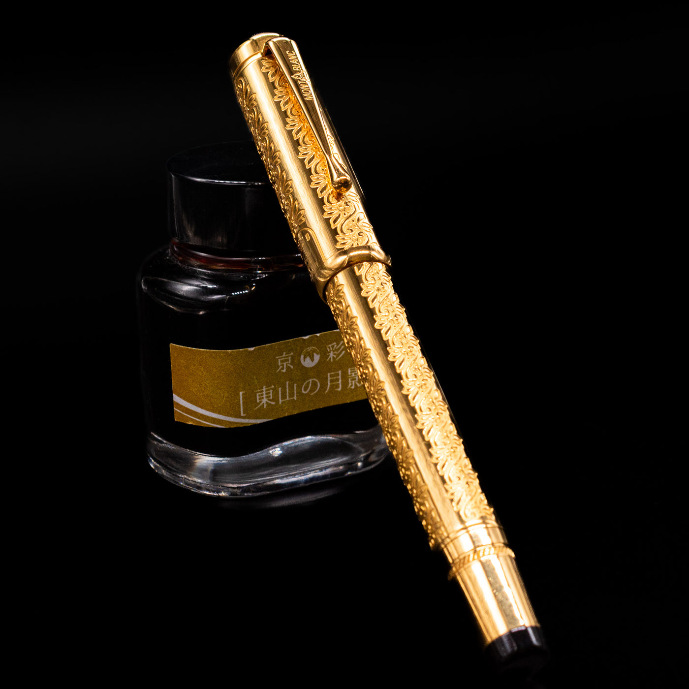 Montblanc Patron of Art Louis XIV 4810 Fountain Pen capped and leaning on ink bottle