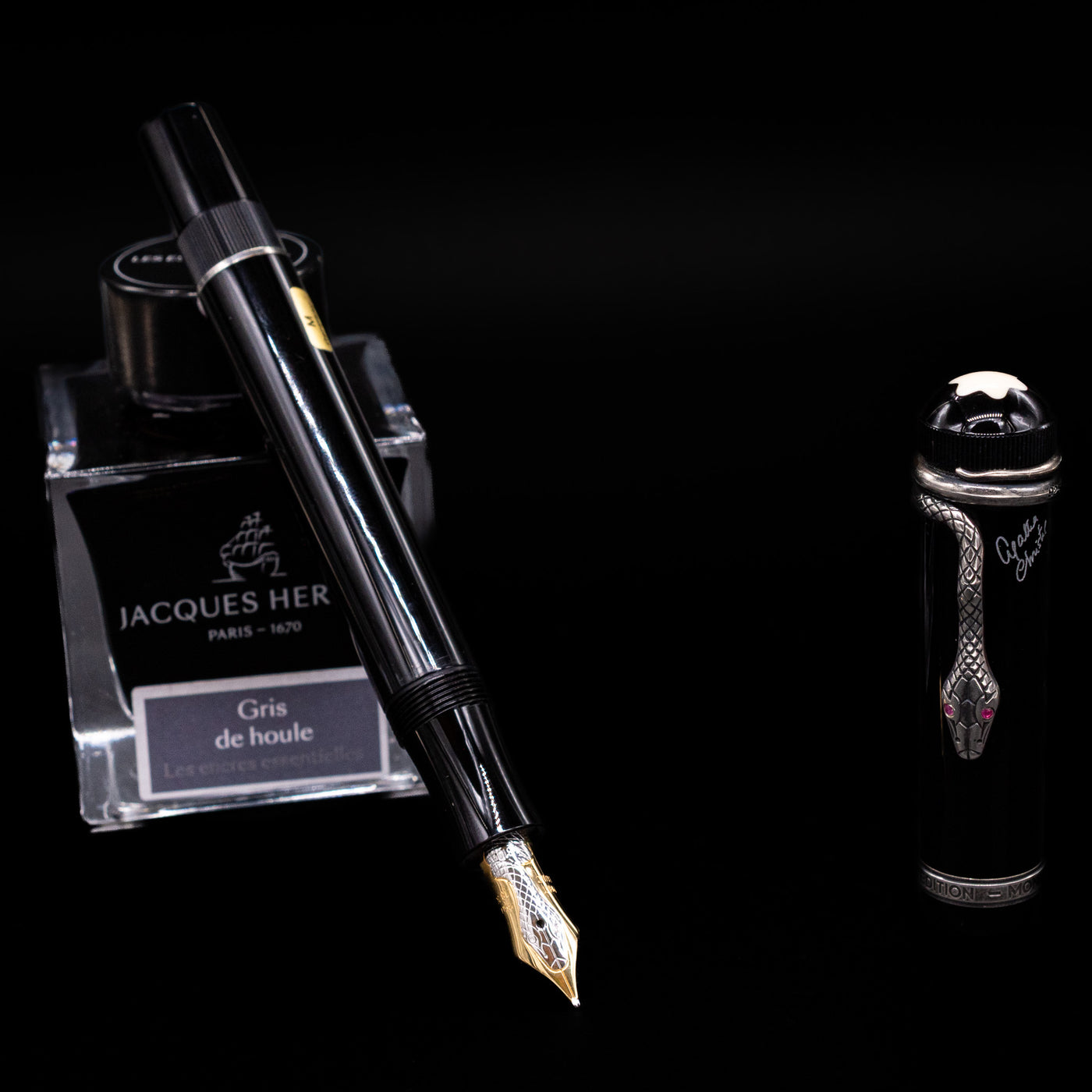 Angled shot of the Montblanc Agatha Christie fountain pen showing the silver snake clip wrapped around the black barrel.