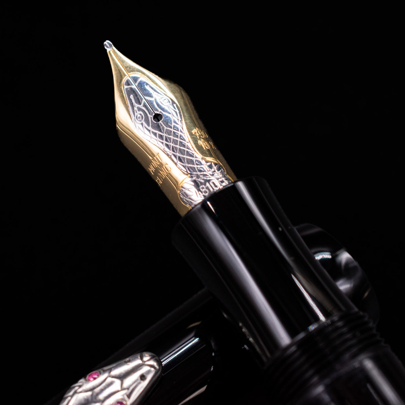 Close-up of the Montblanc Agatha Christie fountain pen’s 18k gold nib, engraved with a snake design.