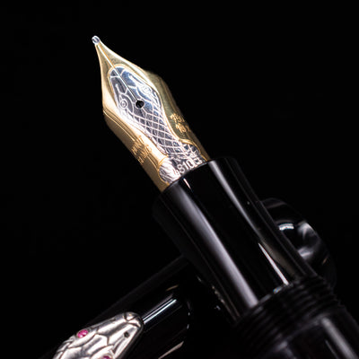 Close-up of the Montblanc Agatha Christie fountain pen’s 18k gold nib, engraved with a snake design.