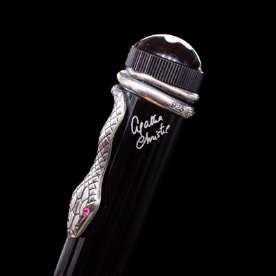 Close-up of the intricate snake clip on the Agatha Christie pen, with red gemstone eyes and engraved scales.