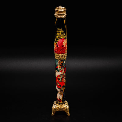 Capped Montegrappa Bijo-To-Yaju fountain pen resting in its sterling silver display stand

