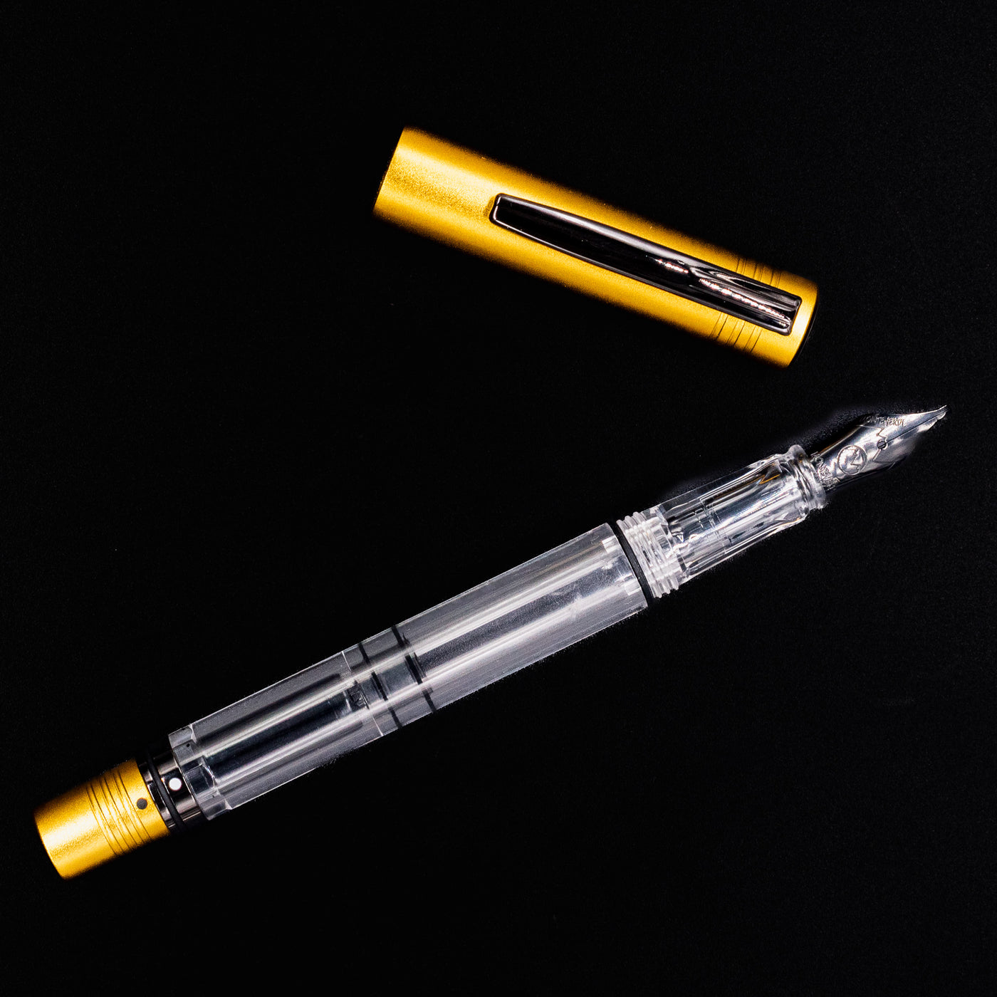 Top-down view of the Monteverde MP1 Honey Yellow Fountain Pen uncapped, highlighting the full transparent barrel and gold-colored ends.