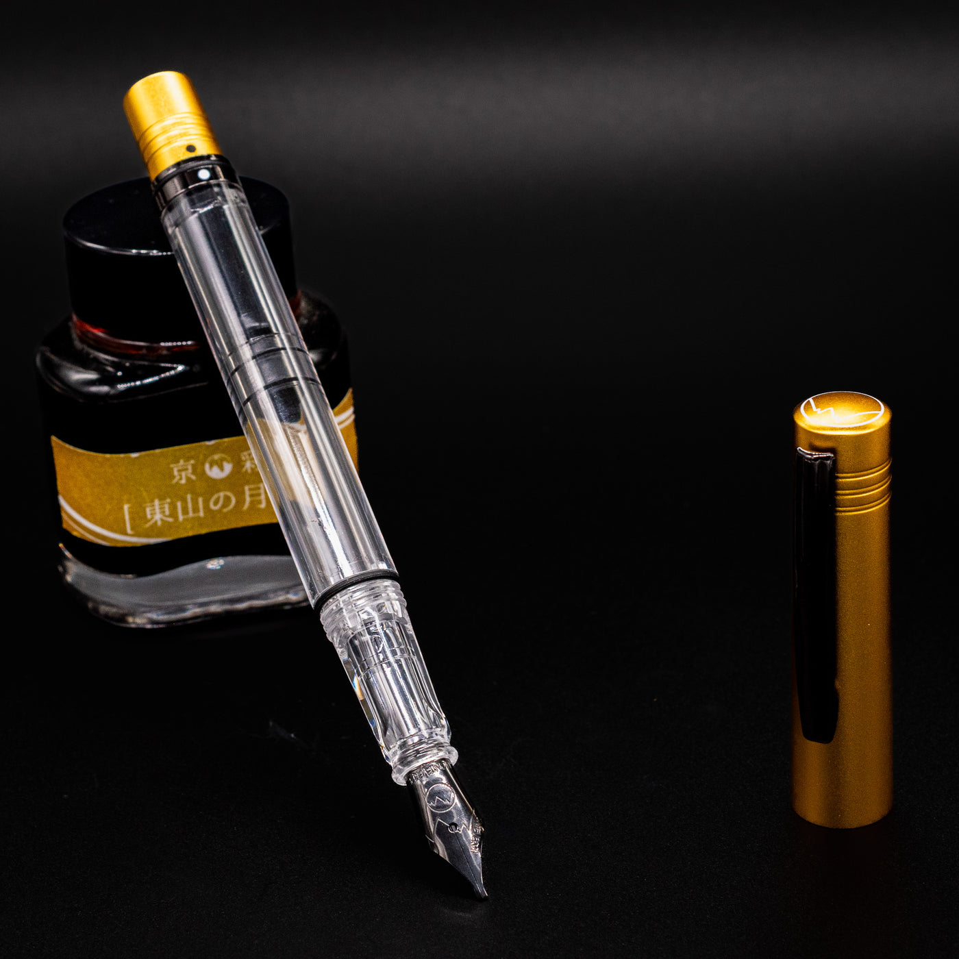 Monteverde MP1 Honey Yellow Fountain Pen uncapped with nib exposed, standing upright beside its cap and ink bottle.