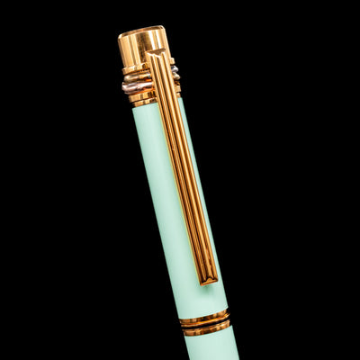 Close-up of Must de Cartier Tiffany Blue pen cap showing signature Trinity ring detail and gold clip