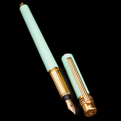 Full view of Must de Cartier Tiffany Blue Fountain Pen with cap off, showcasing gold-plated trim and fine nib