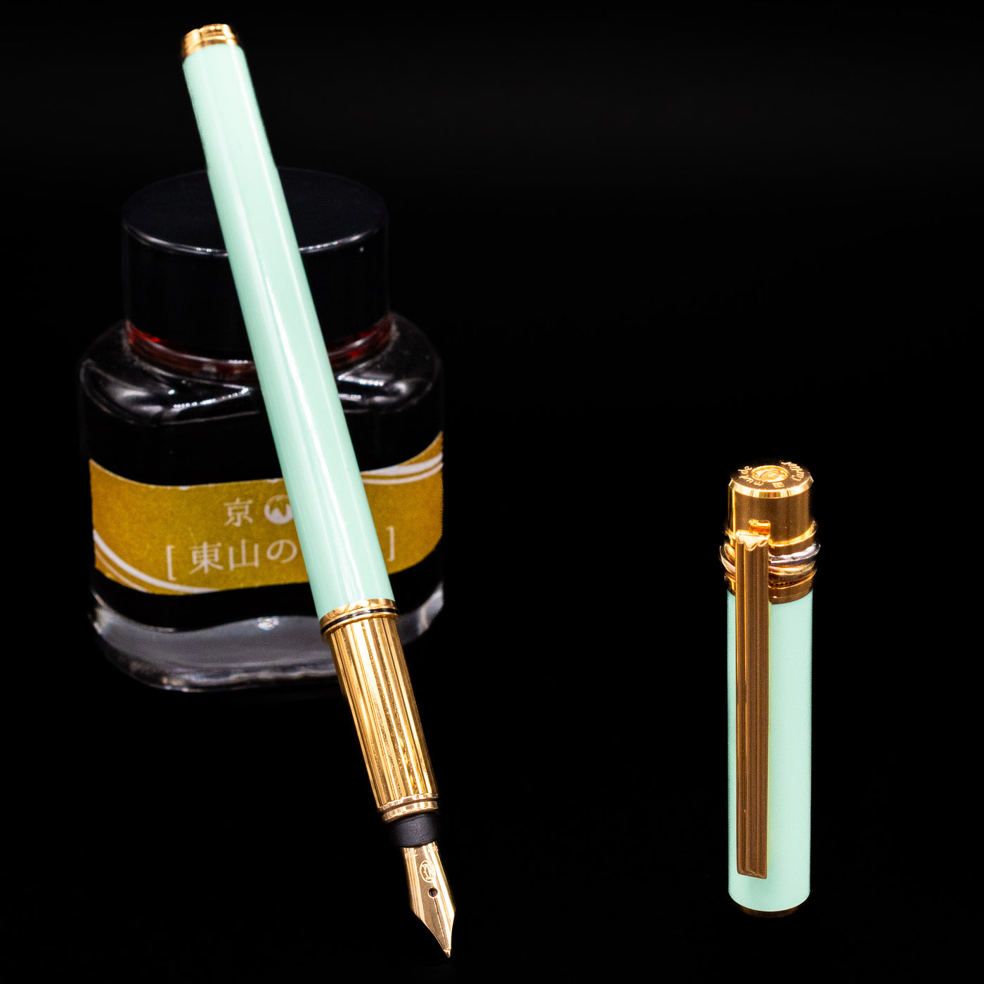 Must de Cartier Trinity Fountain Pen in Tiffany Blue with gold nib, resting on Kyo no Oto ink bottle