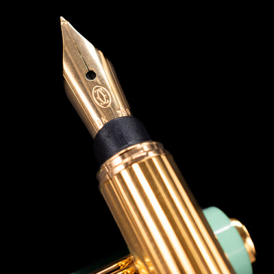 Macro close-up of Must de Cartier Trinity Fountain Pen gold nib with engraved 18k 750 markings