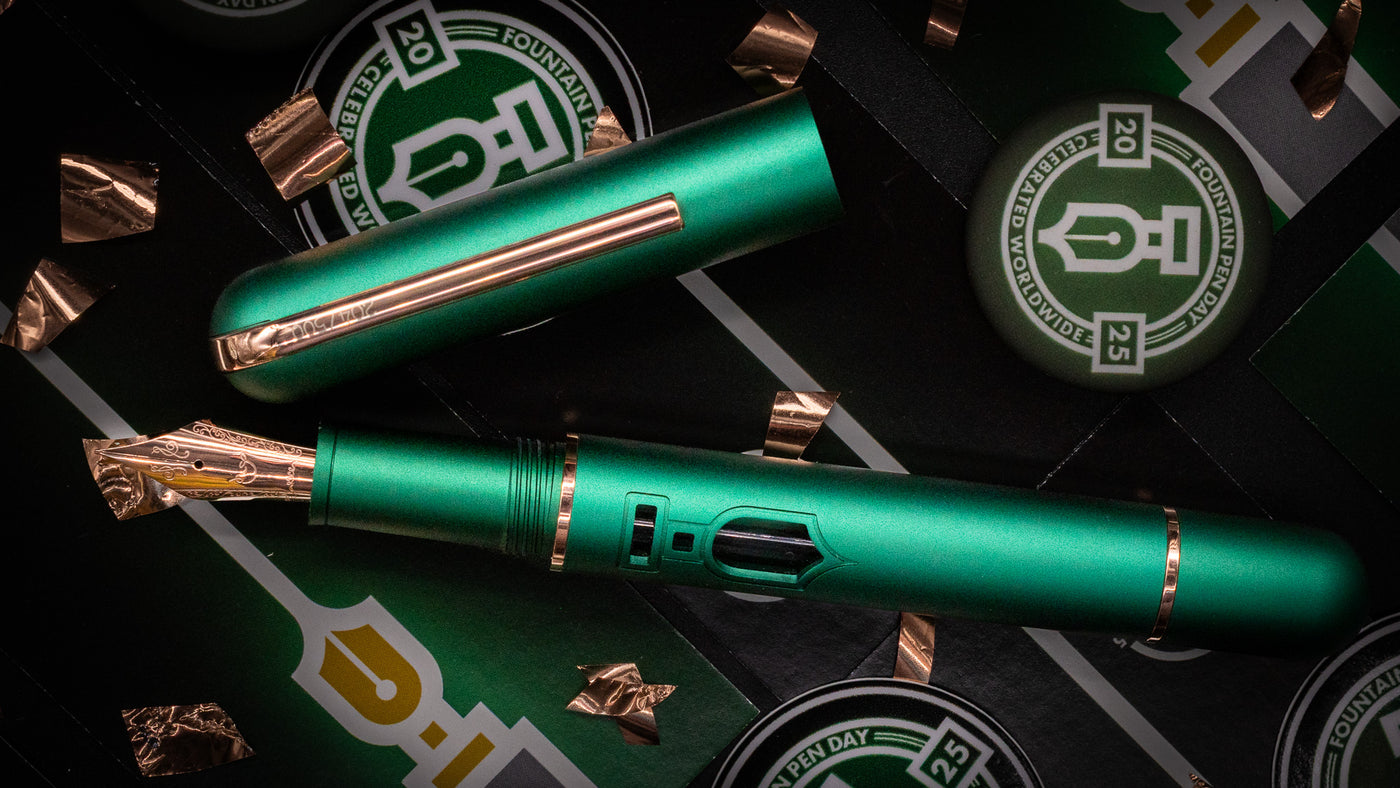 green and rose gold Nahvalur Nautilus fountain pen made for Fountain Pen Day 2025, with the logo for an ink window