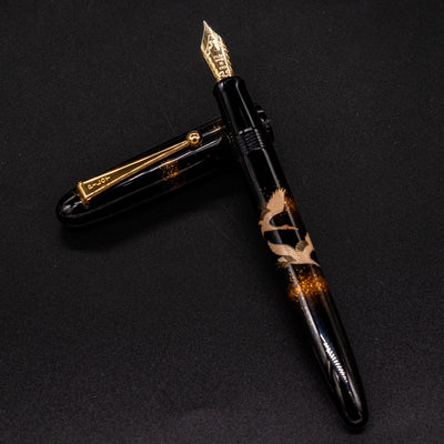 Namiki Yukari Double Crane pen body resting on cap with Urushi lacquer finish.