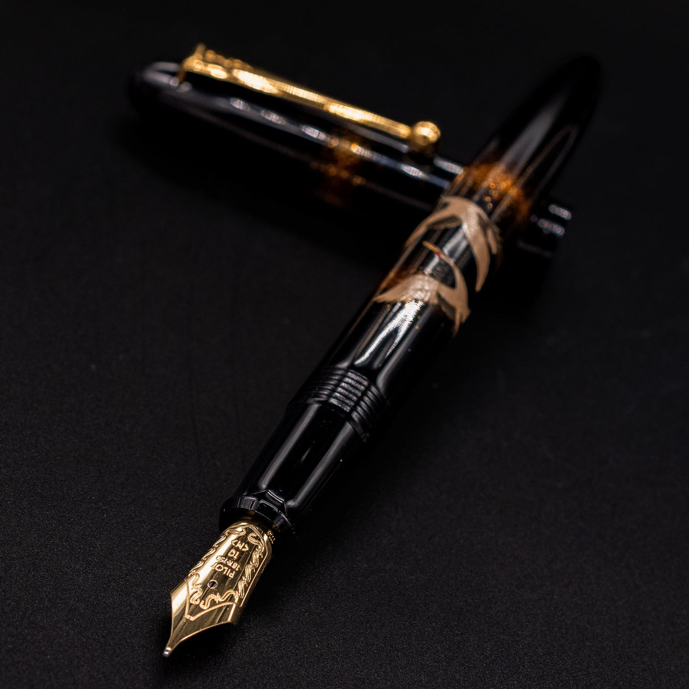 Closeup of Namiki Yukari Double Crane 18k gold nib angled toward camera.