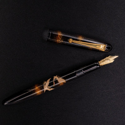 Overhead shot of Namiki Yukari Double Crane fountain pen with gold trim.