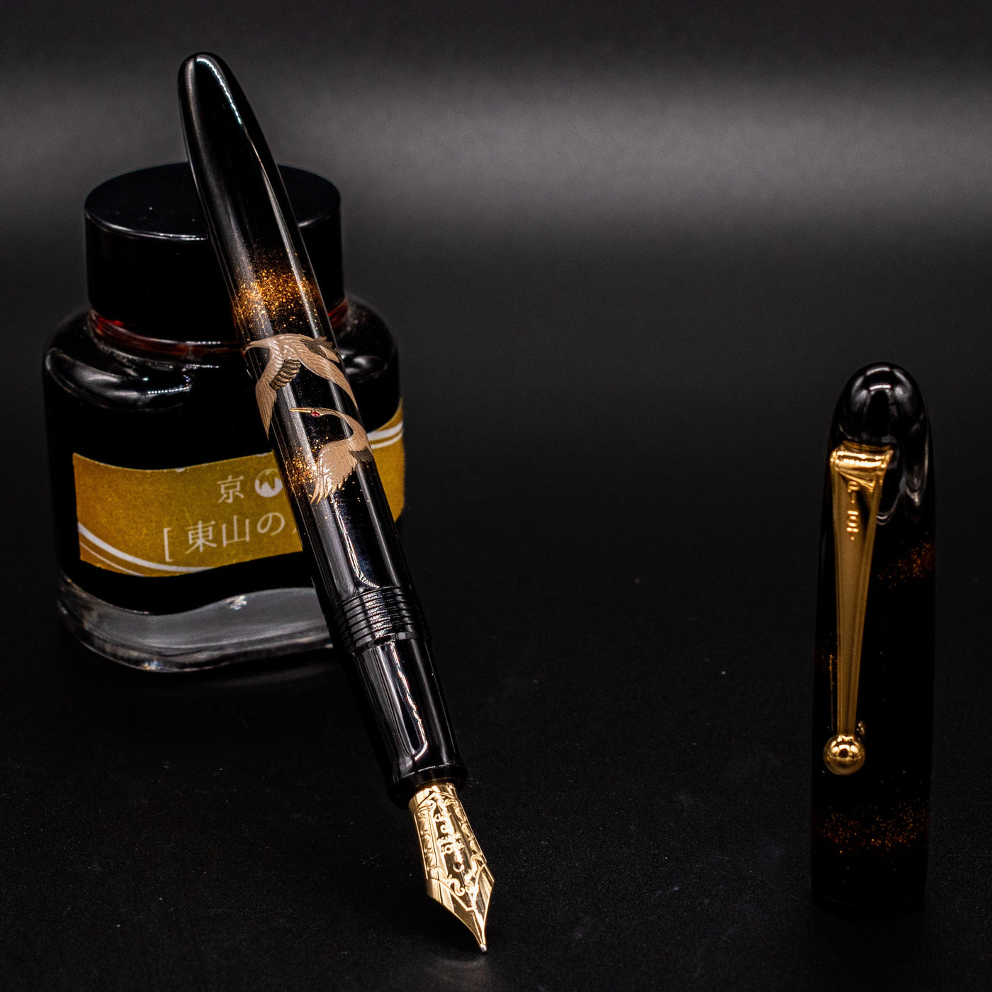 Namiki Yukari Double Crane Maki-e fountain pen uncapped on ink bottle