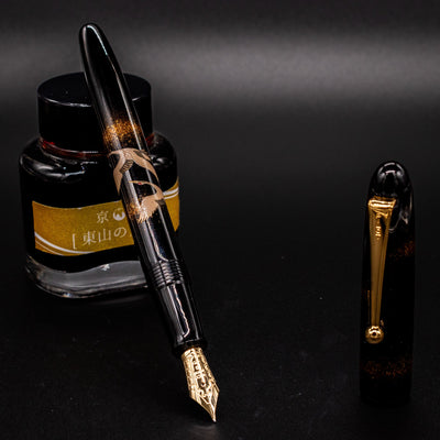 Namiki Yukari Double Crane Maki-e fountain pen uncapped on ink bottle