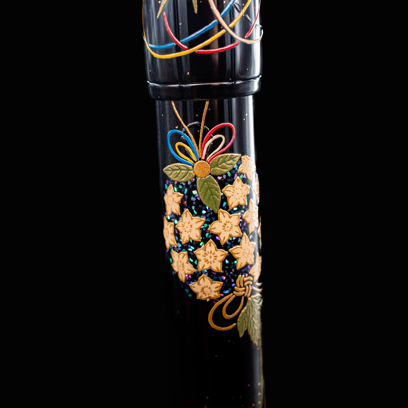 Close-up of top barrel design on Namiki Yukari Maki-e Fountain Pen with golden flowers and green leaves