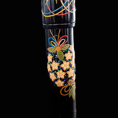 Close-up of top barrel design on Namiki Yukari Maki-e Fountain Pen with golden flowers and green leaves