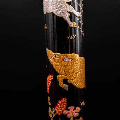 Closeup of Namiki Yukari Zodiac Boar Maki-e artwork on pen barrel - detailed Japanese craftsmanship