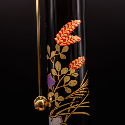 Closeup of Namiki Yukari Zodiac Boar Maki-e artwork on pen cap - detailed Japanese craftsmanship