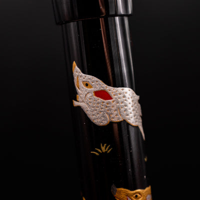 Closeup of Namiki Yukari Zodiac Pig Maki-e artwork on pen barrel - detailed Japanese craftsmanship