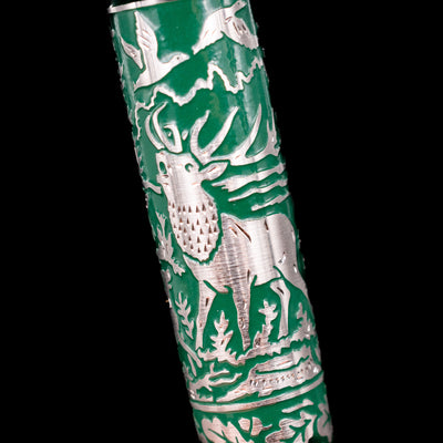 Detailed image of engraved deer and forest trees on the barrel of the Pelikan M915 Hunting Fountain Pen