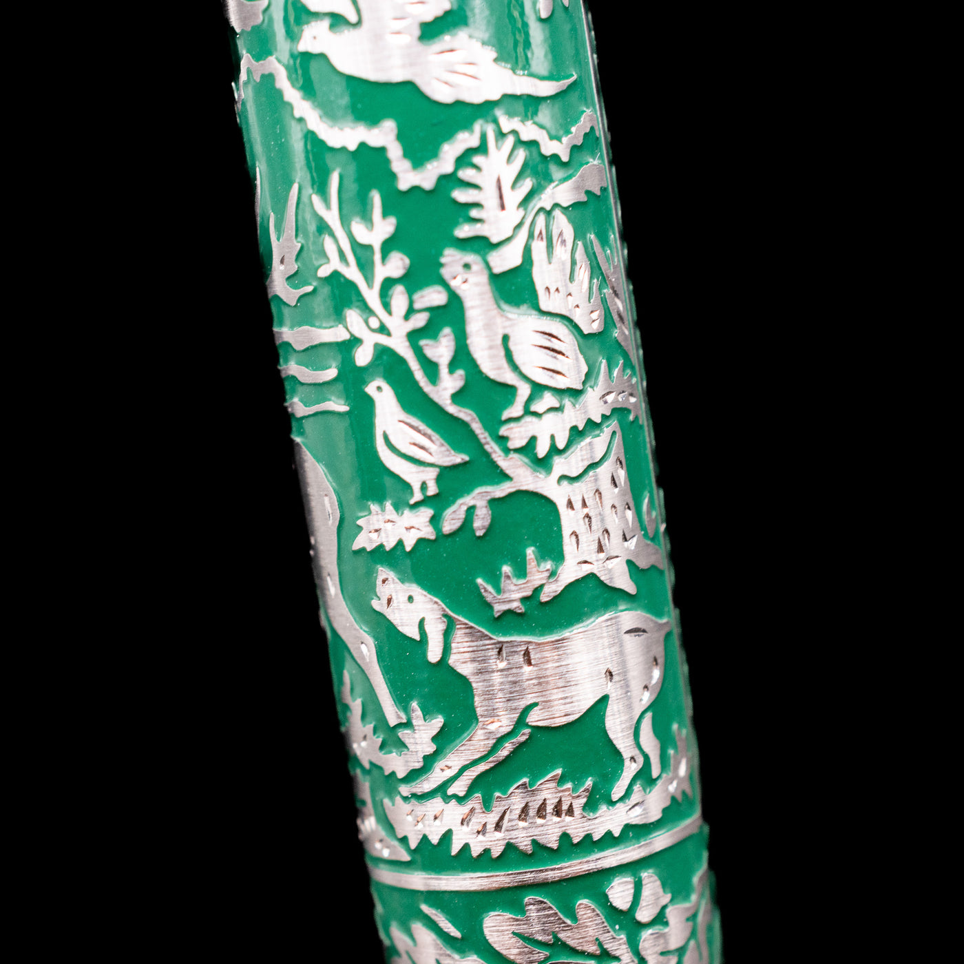 Barrel detail of Pelikan M915 Hunting Fountain Pen showing engraved hunting dog in forest scene