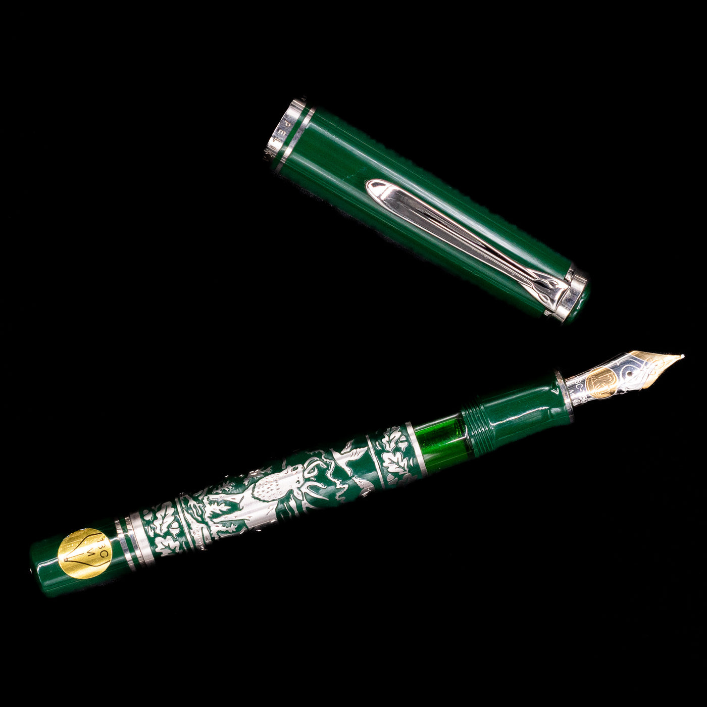 Pelikan M915 Hunting Limited Edition 1994 Fountain Pen shown uncapped from a side angle with engraved silver overlay and green barrel