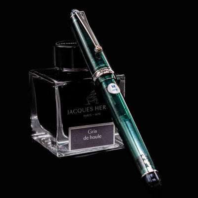 Pilot Custom 74 Forest Green fountain pen resting on Jacques Herbin Gris de Houle ink bottle