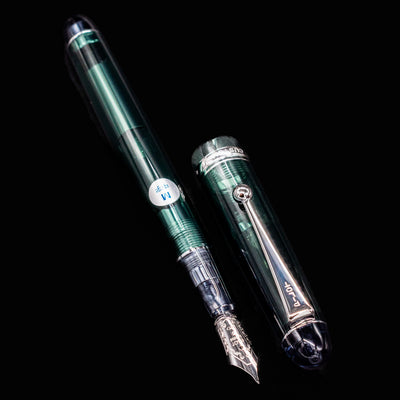 Pilot Custom 74 Forest Green fountain pen open with cap placed beside body on black background