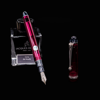 Pilot Custom 74 Merlot fountain pen resting on Jacques Herbin ink bottle with cap removed and nib exposed