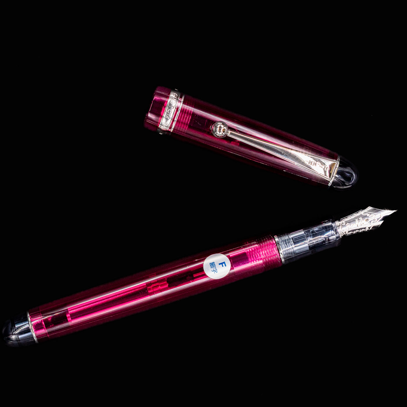 Pilot Custom 74 Merlot fountain pen uncapped with silver nib pointing upward, cap laid flat beside it
