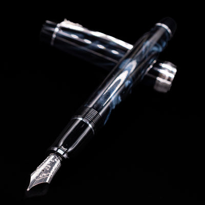 Flatlay of the uncapped Pilot Custom Heritage SE Fountain Pen in Blue Marble showing nib and body.