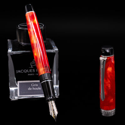 Pilot Custom Heritage SE Fountain Pen in Orange Marble finish, uncapped and angled to show nib and translucent body