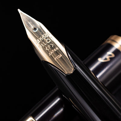 Close-up of Pilot E95S gold nib with engraved details on black barrel