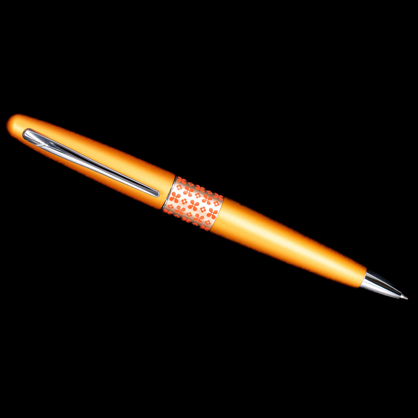Overhead view of the Pilot Metropolitan Pop Ballpoint Pen in Orange showing the full sleek barrel and floral band design.