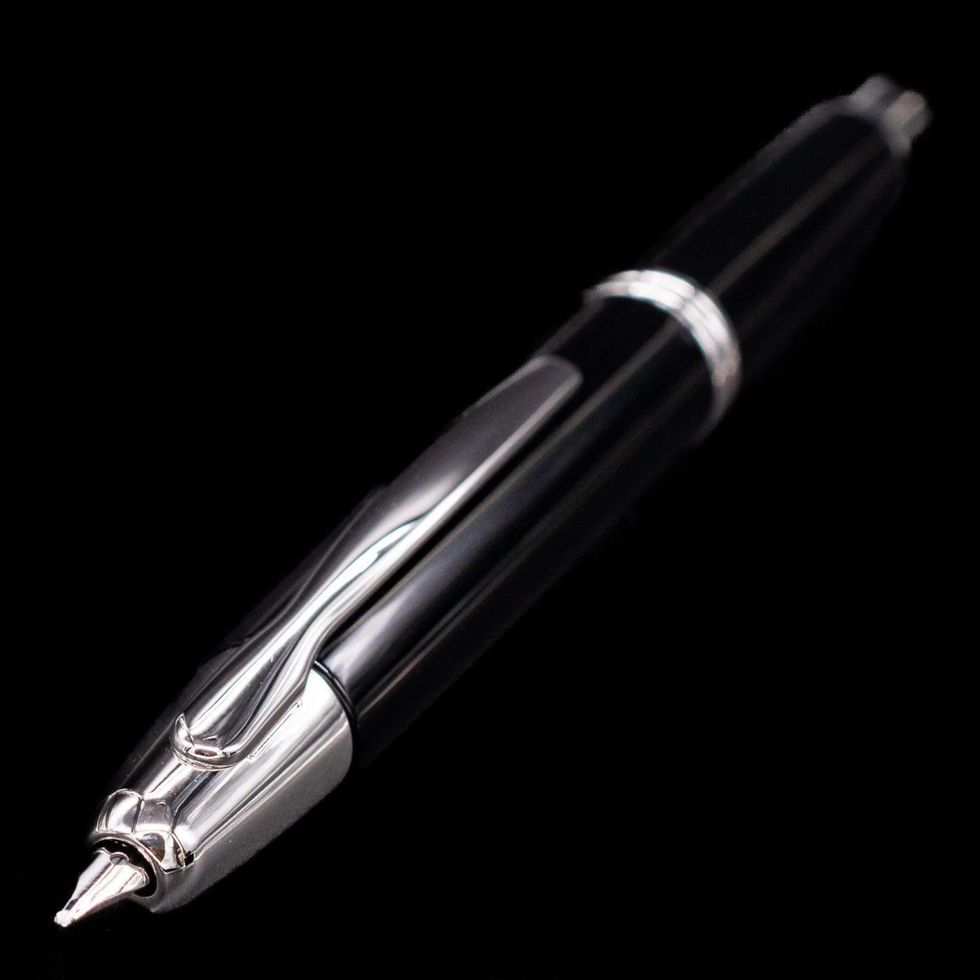 Close-up image of the nib and clip of the Pilot Vanishing Point Decimo Fountain Pen in Black and Rhodium on black background