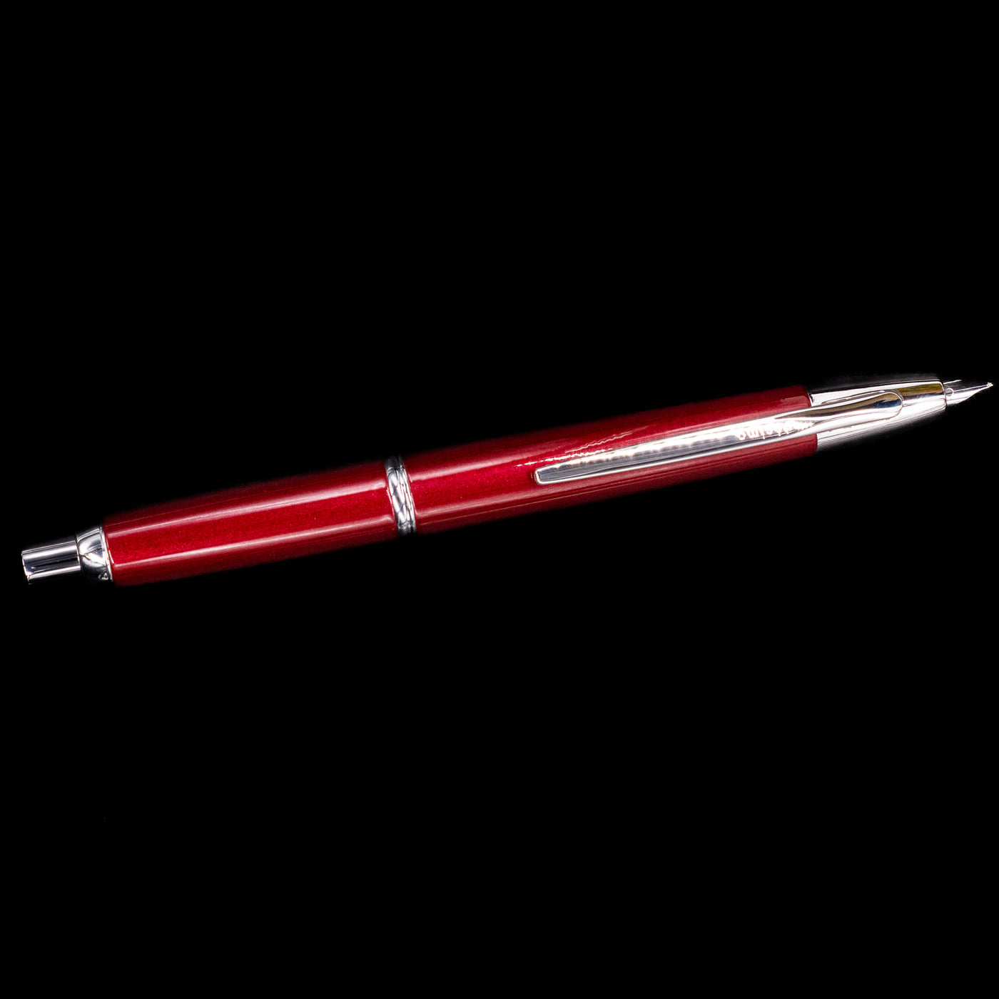Full-length view of Pilot Vanishing Point Decimo Fountain Pen in Burgundy with silver accents on black background