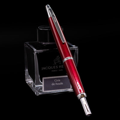 Pilot Vanishing Point Decimo Burgundy Fountain Pen displayed on Jacques Herbin ink bottle showing clip and silver trim