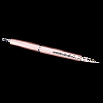 Full-length view of the Pilot Vanishing Point Decimo Champagne Fountain Pen with nib extended on black background