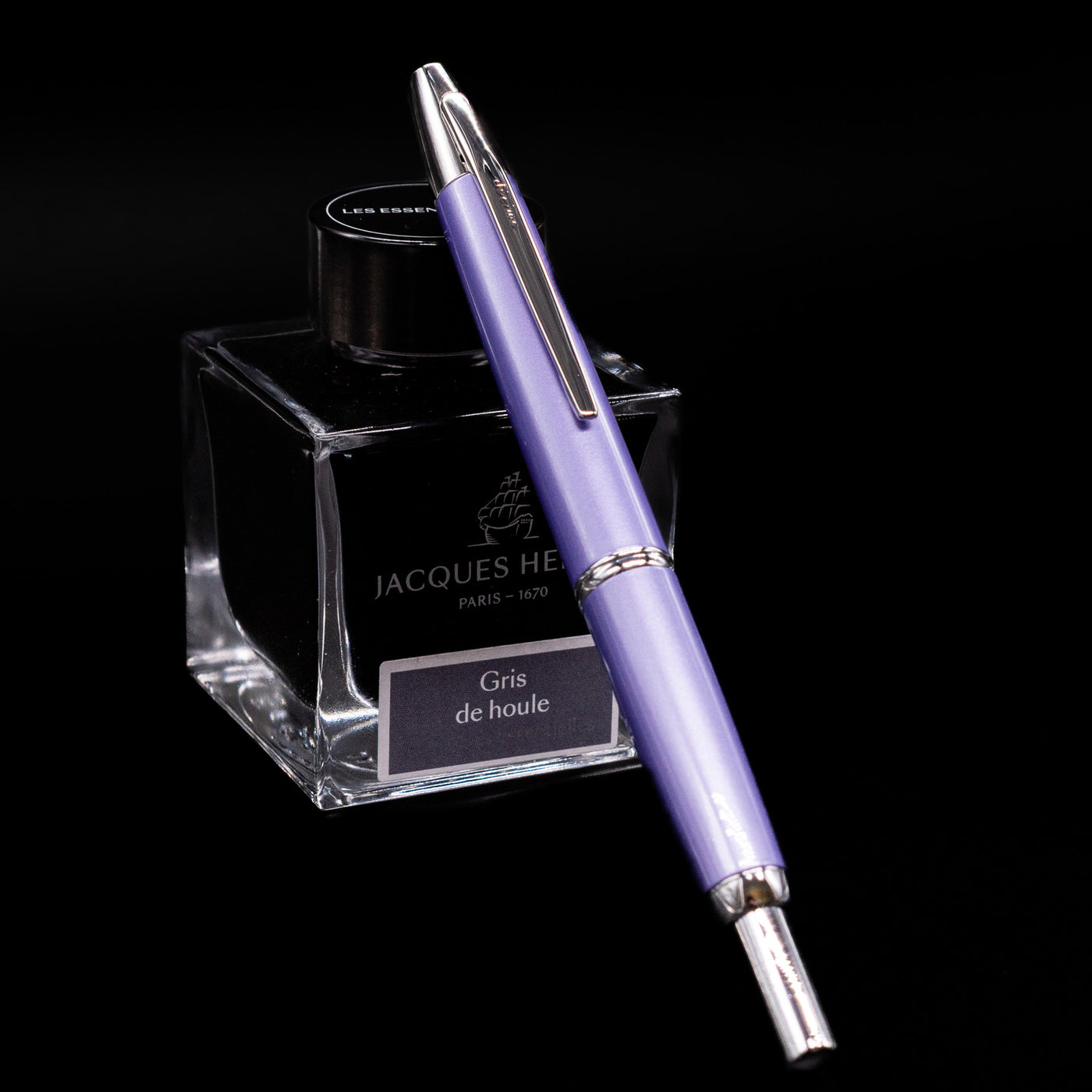 Pilot Vanishing Point Decimo Fountain Pen in Purple capped and resting on Jacques Herbin ink bottle