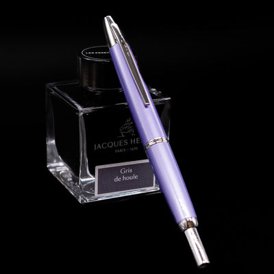 Pilot Vanishing Point Decimo Fountain Pen in Purple capped and resting on Jacques Herbin ink bottle